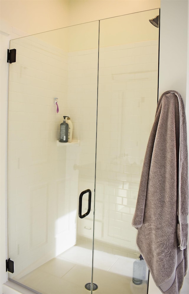 bathroom with a shower with shower door