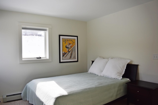 carpeted bedroom with a baseboard heating unit