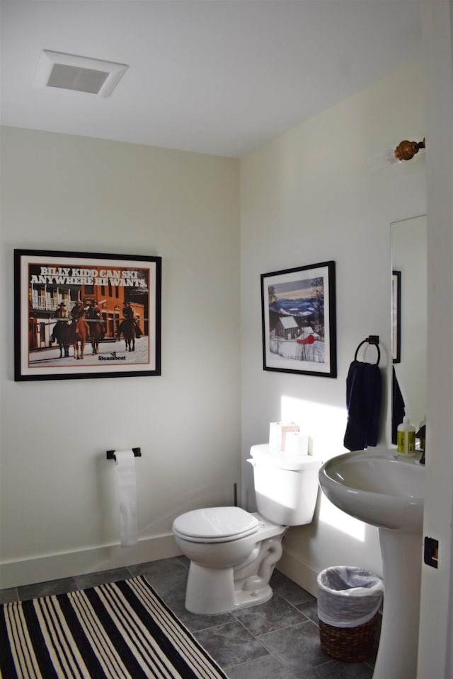 bathroom featuring tile patterned flooring and toilet