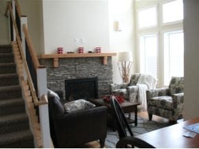 living room featuring a stone fireplace