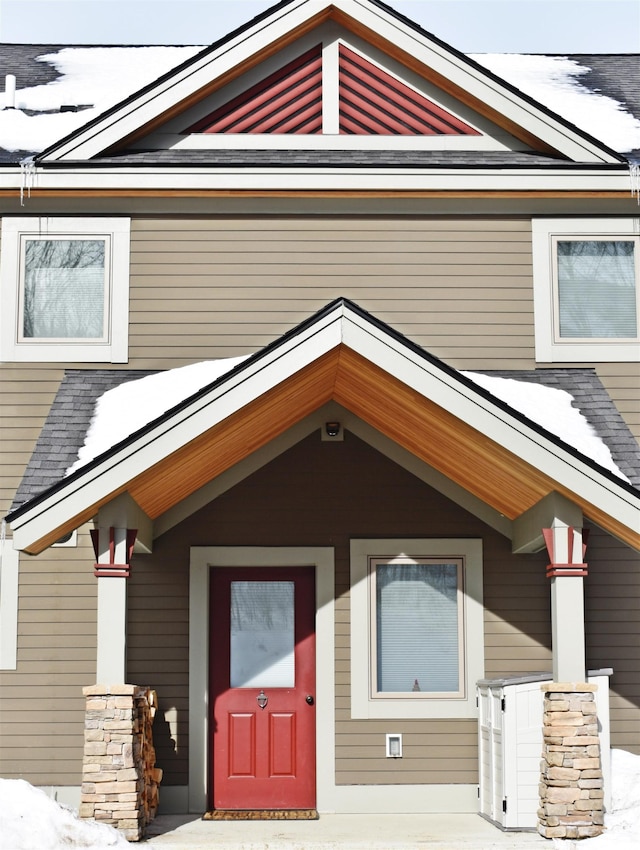 view of snow covered property entrance