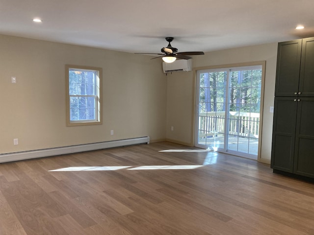 unfurnished room with ceiling fan, light hardwood / wood-style flooring, a baseboard radiator, and a wall mounted AC