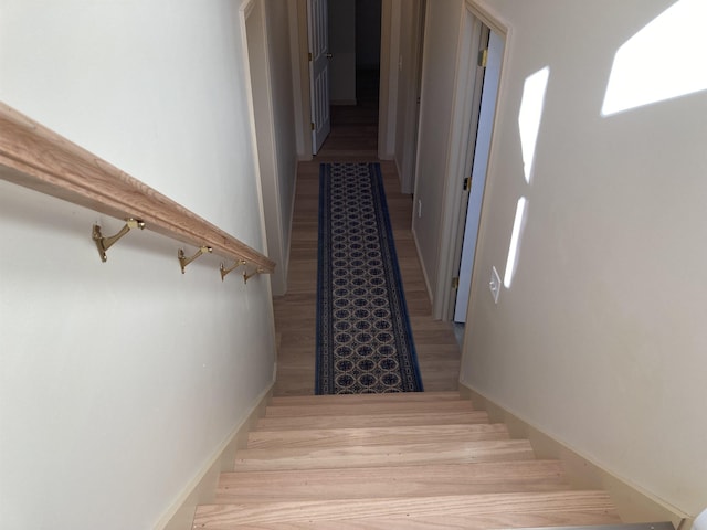 stairs featuring wood-type flooring