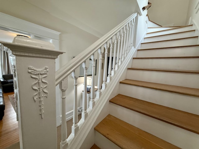 staircase featuring wood-type flooring