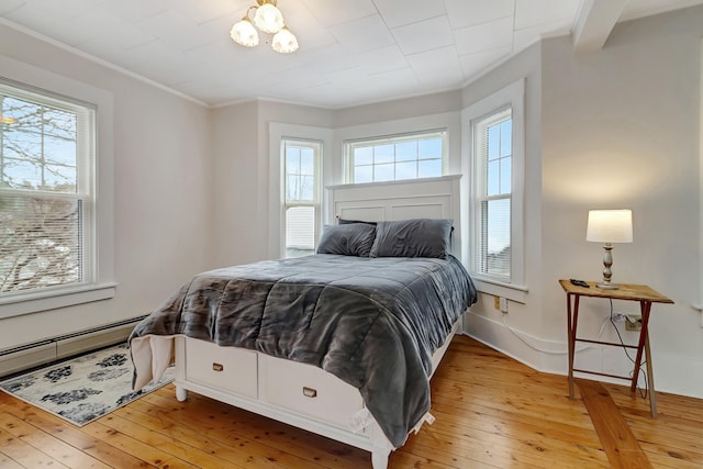 bedroom featuring light hardwood / wood-style flooring and ornamental molding