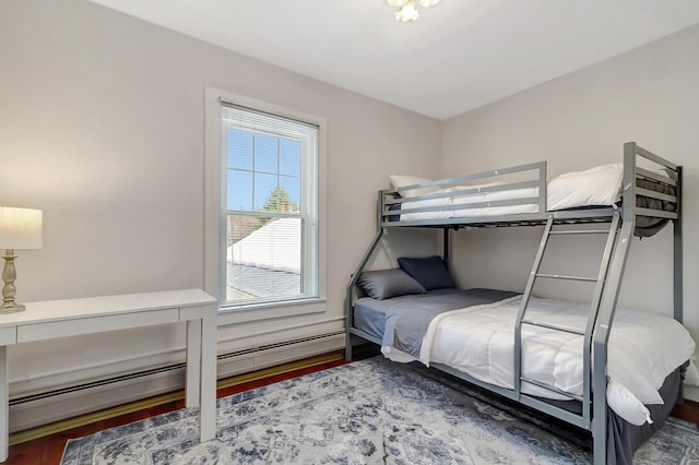 bedroom with hardwood / wood-style flooring and a baseboard radiator