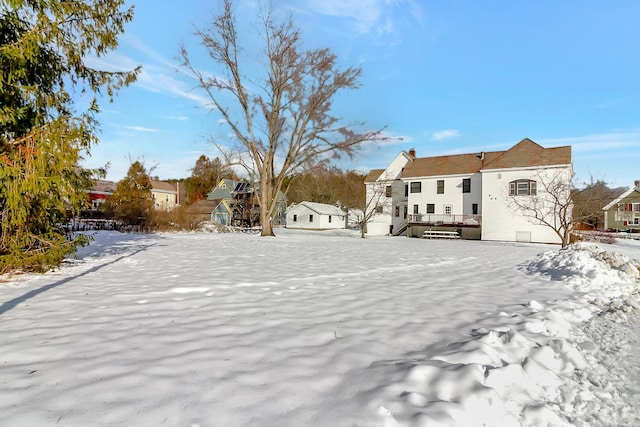 snowy yard with a wooden deck