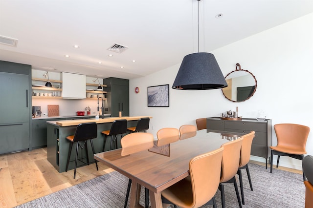 dining area featuring light hardwood / wood-style flooring and sink