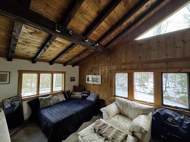 bedroom with vaulted ceiling with beams, wooden ceiling, wooden walls, and multiple windows