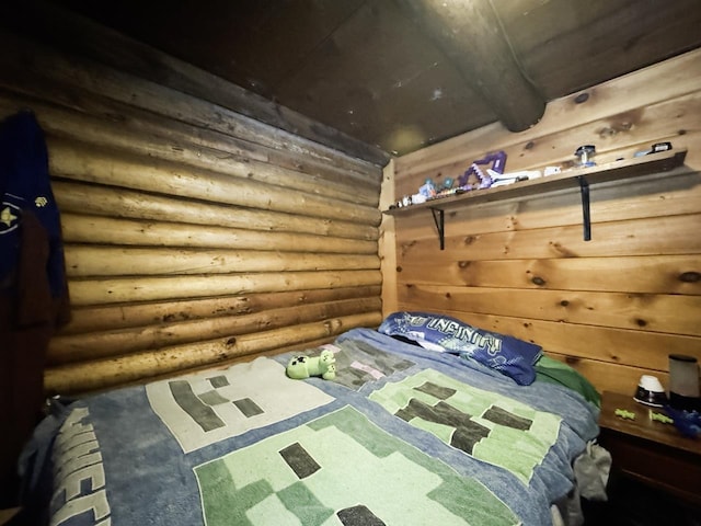 unfurnished bedroom with log walls, carpet, and beamed ceiling