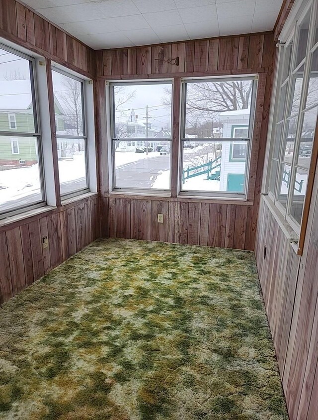 unfurnished sunroom featuring a wealth of natural light