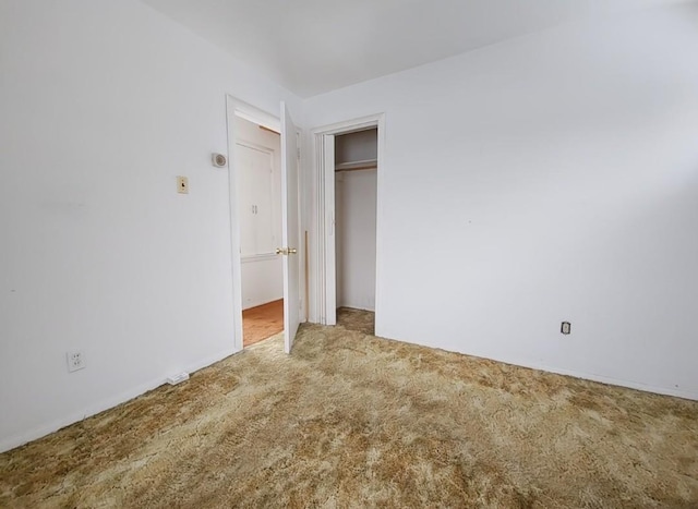 unfurnished bedroom with a closet and carpet