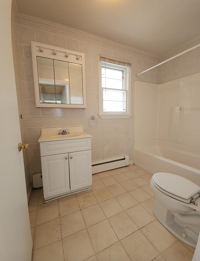 full bathroom with vanity, ornamental molding, baseboard heating, and tile walls