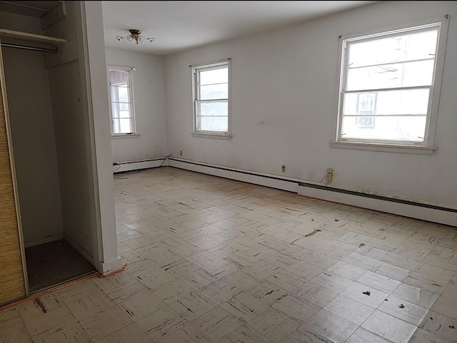 interior space featuring a healthy amount of sunlight and a baseboard radiator