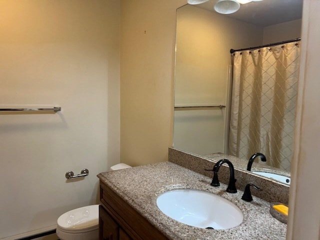 bathroom with vanity, a baseboard radiator, and toilet