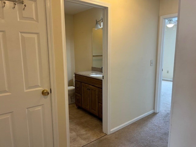 bathroom featuring tile patterned floors, vanity, and toilet