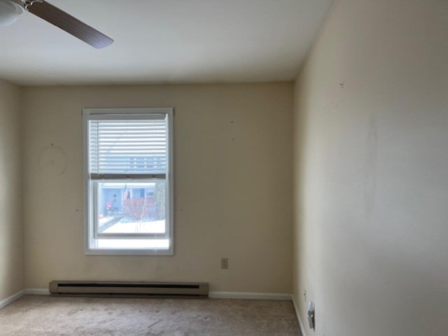 carpeted spare room featuring ceiling fan and a baseboard radiator