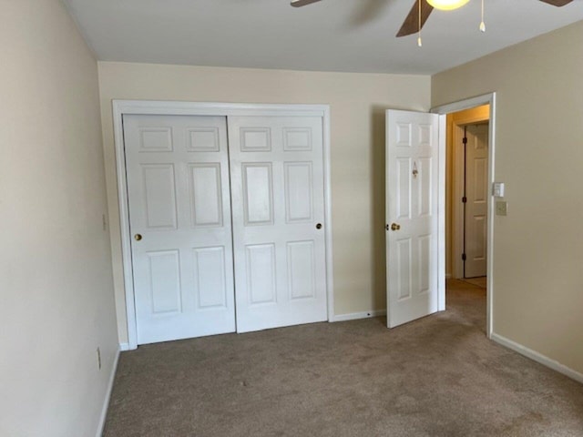 unfurnished bedroom featuring a closet, dark carpet, and ceiling fan