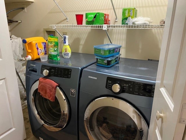 clothes washing area with washing machine and dryer