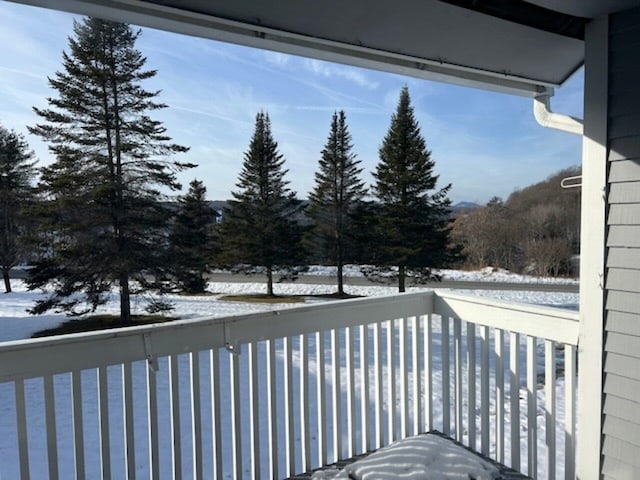 view of snow covered back of property