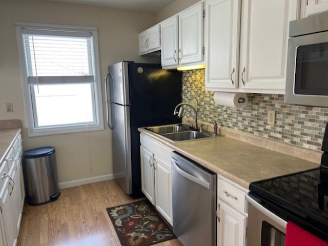 kitchen with white cabinetry, sink, a healthy amount of sunlight, and appliances with stainless steel finishes