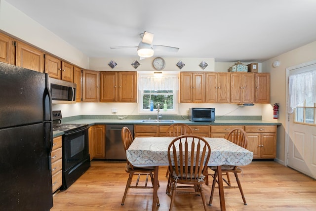 kitchen featuring black appliances, ceiling fan, sink, and light hardwood / wood-style flooring