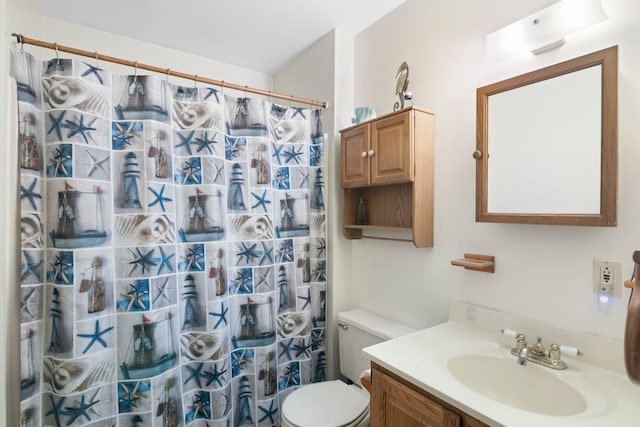 bathroom featuring toilet, a shower with curtain, and vanity