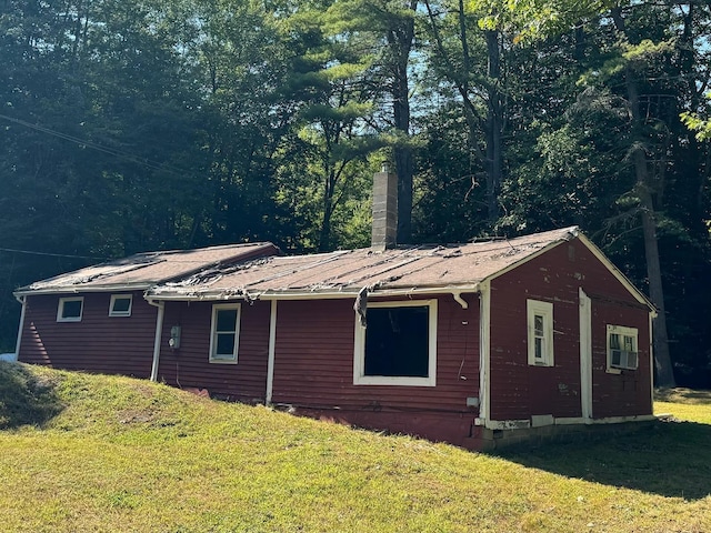 view of side of home with a lawn