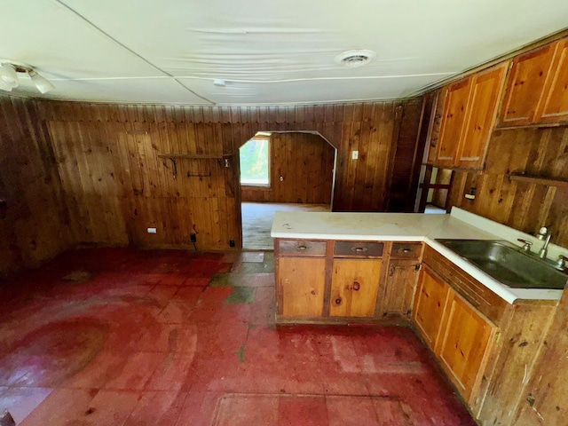 kitchen with wooden walls and sink