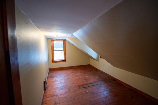 bonus room featuring dark hardwood / wood-style floors and lofted ceiling