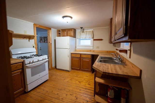 kitchen featuring wooden counters, white appliances, crown molding, sink, and light hardwood / wood-style floors