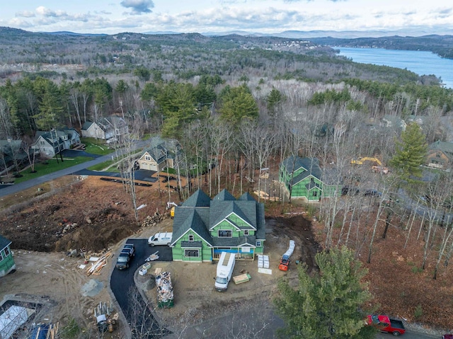 birds eye view of property with a water and mountain view