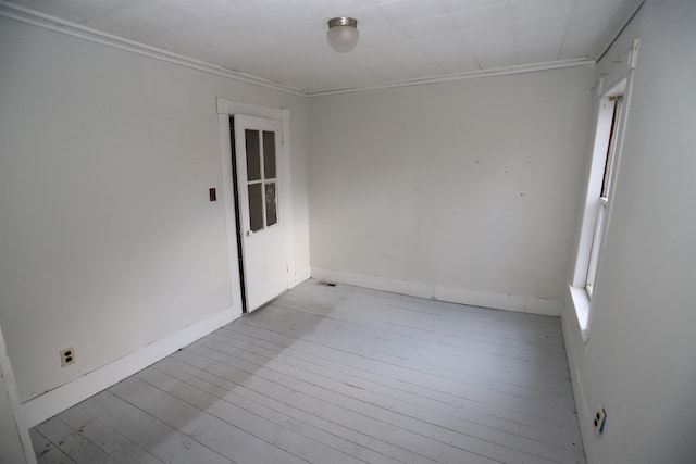 unfurnished room with light wood-type flooring and ornamental molding