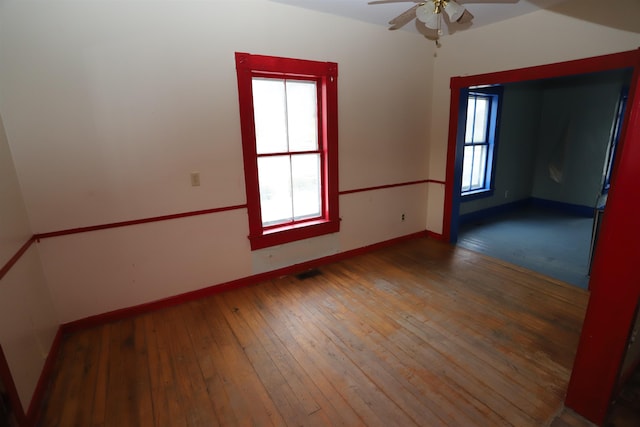 empty room featuring hardwood / wood-style floors and ceiling fan