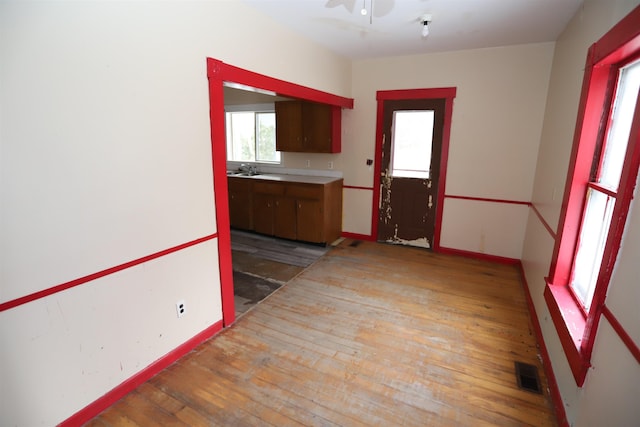 kitchen with light wood-type flooring and ceiling fan