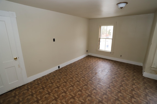 spare room with dark parquet flooring