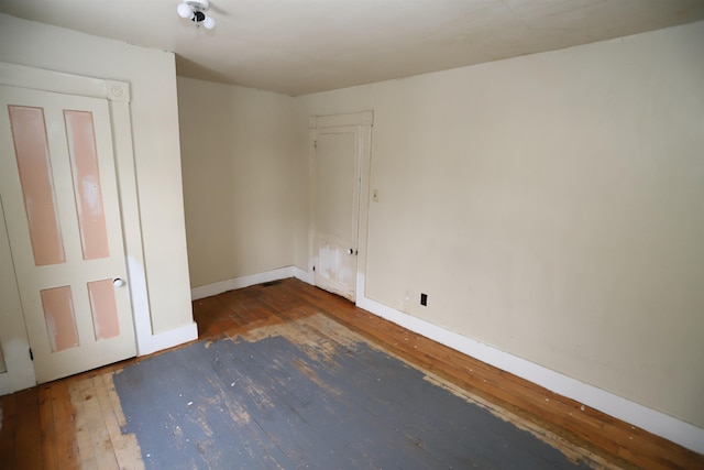 unfurnished room featuring dark wood-type flooring