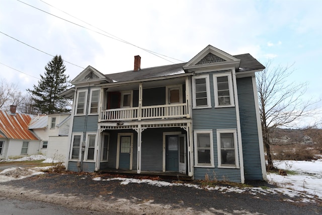 view of front facade with a balcony and a porch