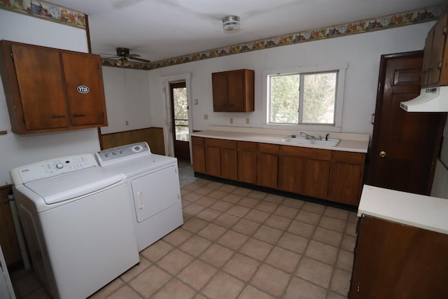 washroom featuring cabinets, a wealth of natural light, washer and clothes dryer, and sink