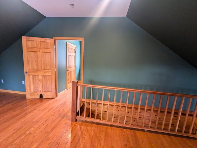 bonus room featuring wood-type flooring and vaulted ceiling