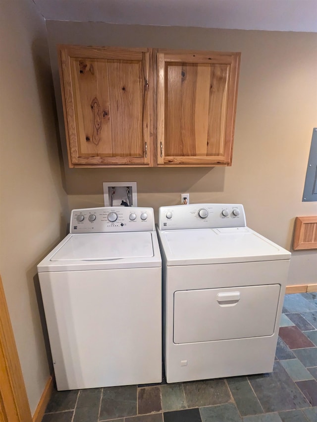 laundry area with separate washer and dryer, electric panel, and cabinets