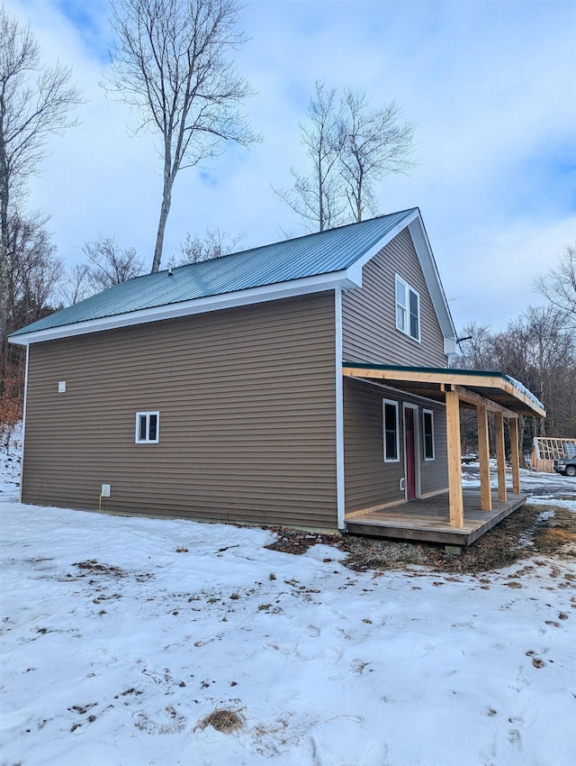 view of snowy exterior with a porch