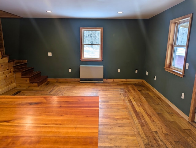 spare room with plenty of natural light and light hardwood / wood-style flooring