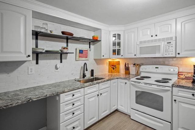 kitchen with white cabinets, stone countertops, white appliances, and sink