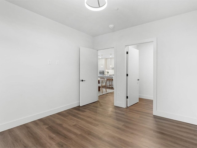 125 Cambrian Way Unit 609, Burlington, VT 05401 - unfurnished bedroom featuring wood finished floors, baseboards, and a desk