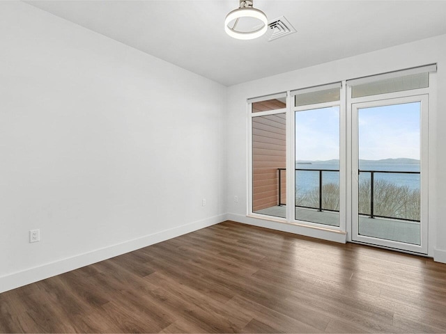 125 Cambrian Way Unit 609, Burlington, VT 05401 - empty room featuring dark wood finished floors, baseboards, and a water view