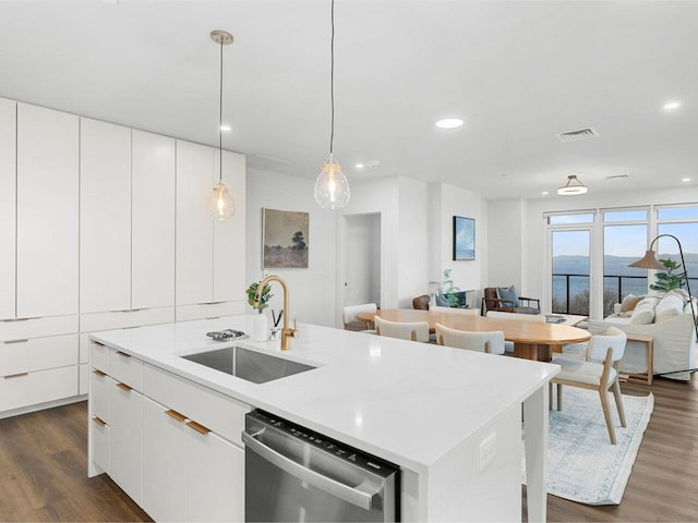 125 Cambrian Way Unit 609, Burlington, VT 05401 - kitchen featuring stainless steel dishwasher, a sink, open floor plan, a center island with sink, and dark wood-style flooring
