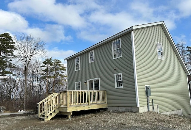 back of property with a wooden deck