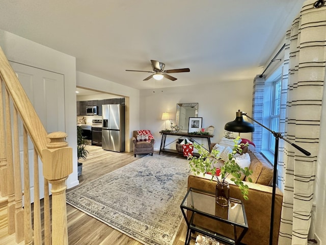 living room featuring hardwood / wood-style floors and ceiling fan