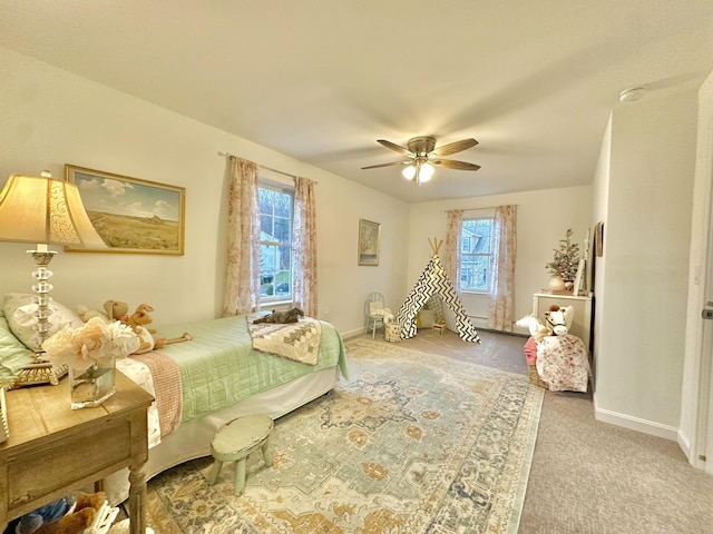 carpeted bedroom with multiple windows and ceiling fan